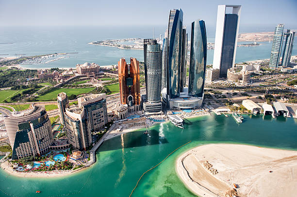 Part of Abu Dhabi, UAE with with skyscrapers and surrounding area viewed from the helicopter. Many details are visible in the image.